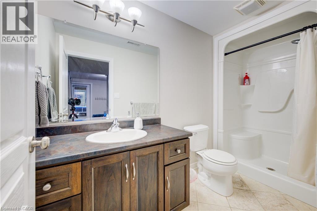 Bathroom with vanity, light tile patterned flooring, and a stall shower - 34 Harrison Street, Stratford, ON - Indoor Photo Showing Bathroom