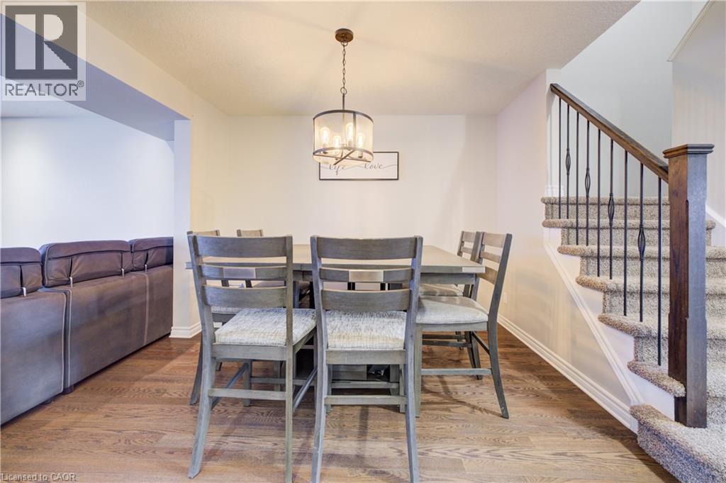 Dining area with a chandelier, stairs, and light wood finished floors - 34 Harrison Street, Stratford, ON - Indoor Photo Showing Dining Room