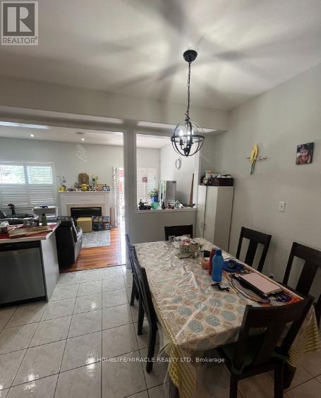 6912 Buttle Station Place, Mississauga, ON - Indoor Photo Showing Dining Room With Fireplace