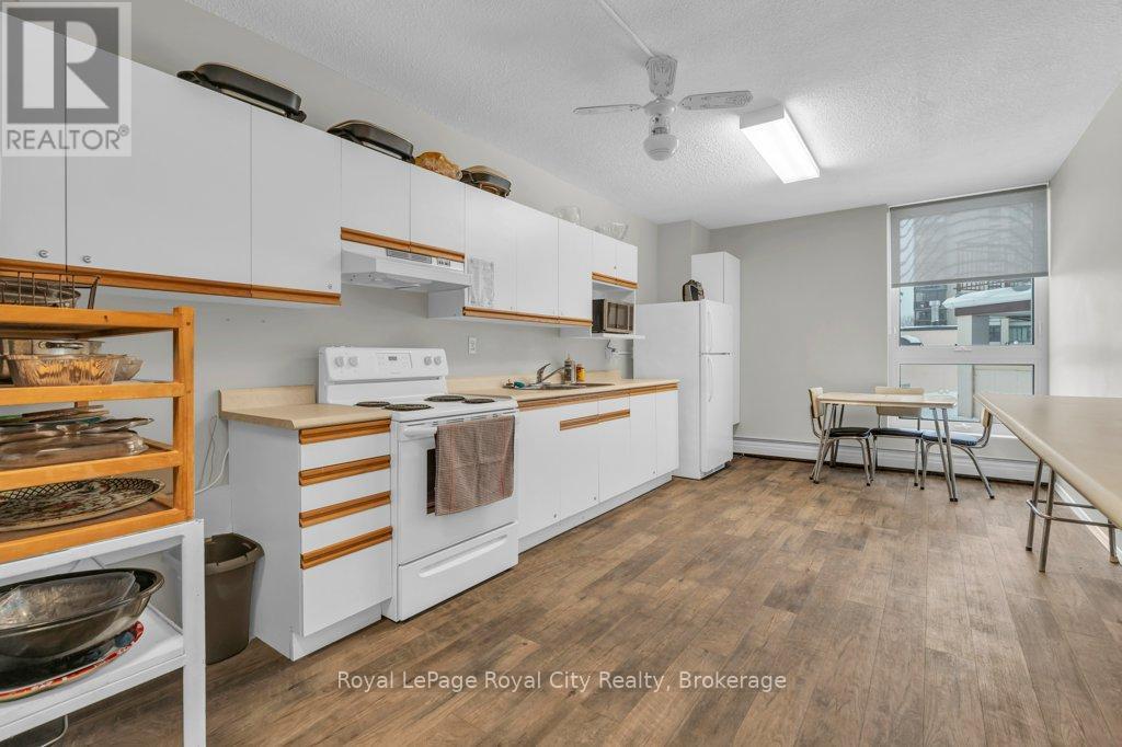 511 - 19 Woodlawn Road E, Guelph (Riverside Park), ON - Indoor Photo Showing Kitchen With Fireplace