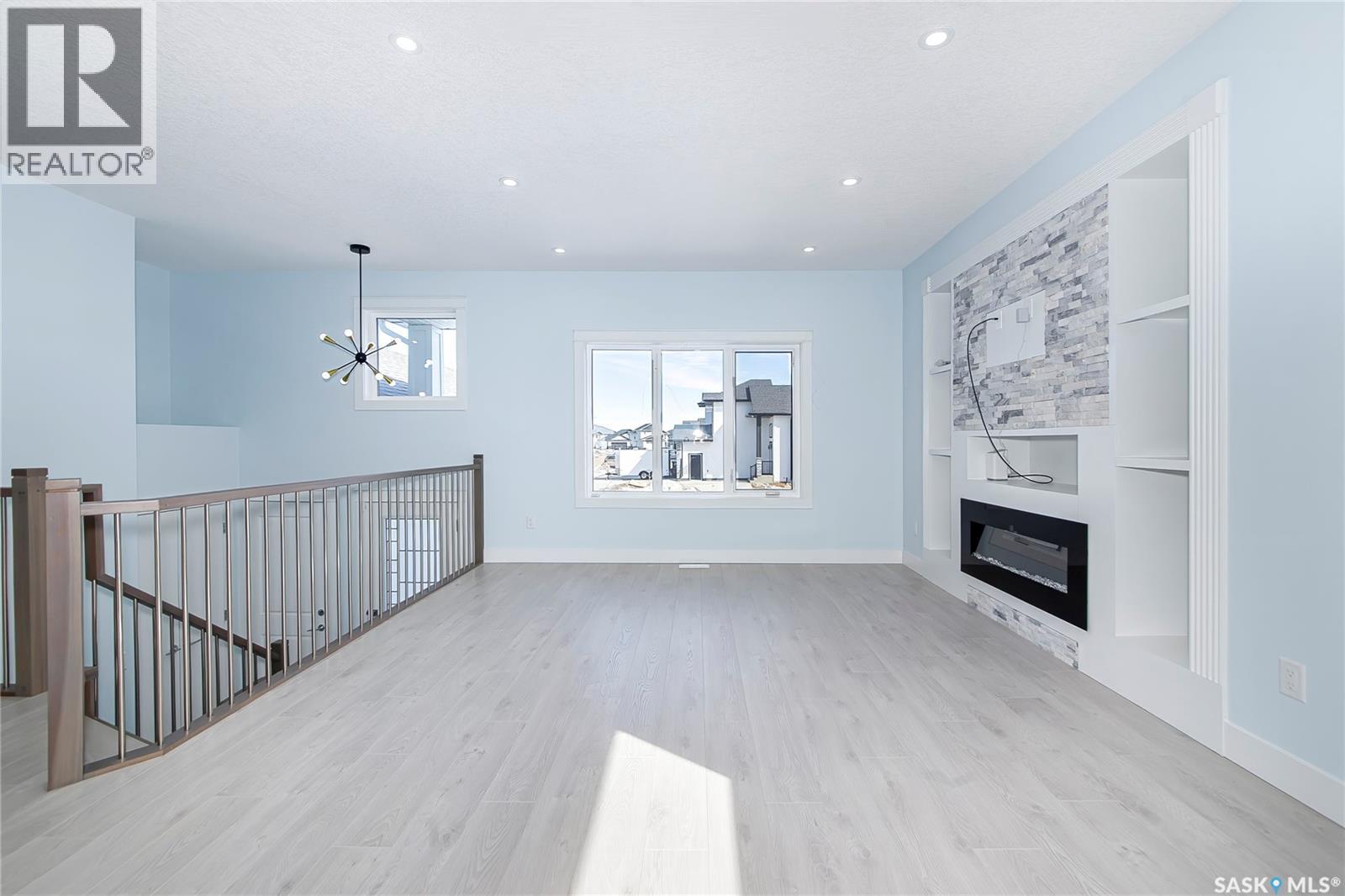 906 Bentley Manor, Saskatoon, SK - Indoor Photo Showing Living Room With Fireplace