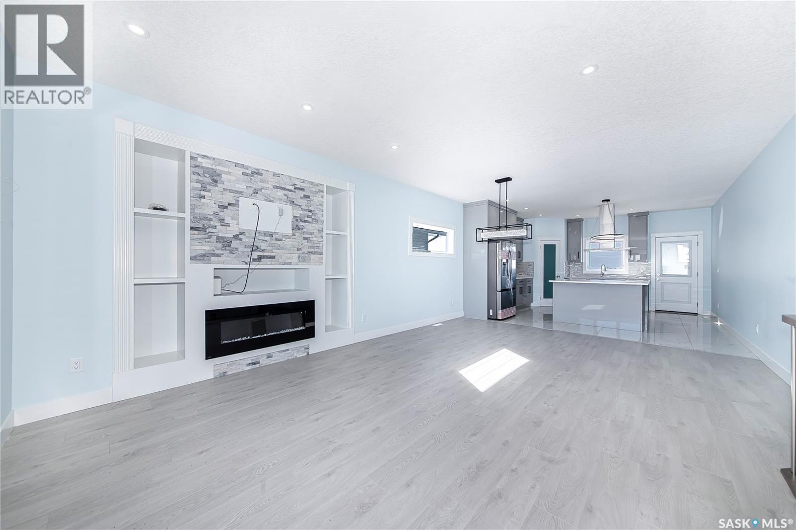 906 Bentley Manor, Saskatoon, SK - Indoor Photo Showing Living Room With Fireplace