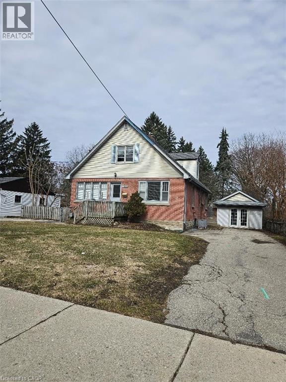 Bungalow with asphalt driveway, an outdoor structure, and a wooden deck - 1154 Queens Boulevard, Kitchener, ON - Outdoor