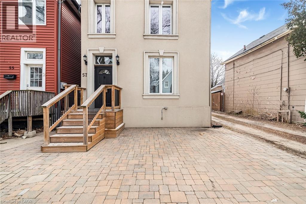 Entrance to property with stucco siding and a patio area - 57 New Street, Hamilton, ON - Outdoor With Exterior
