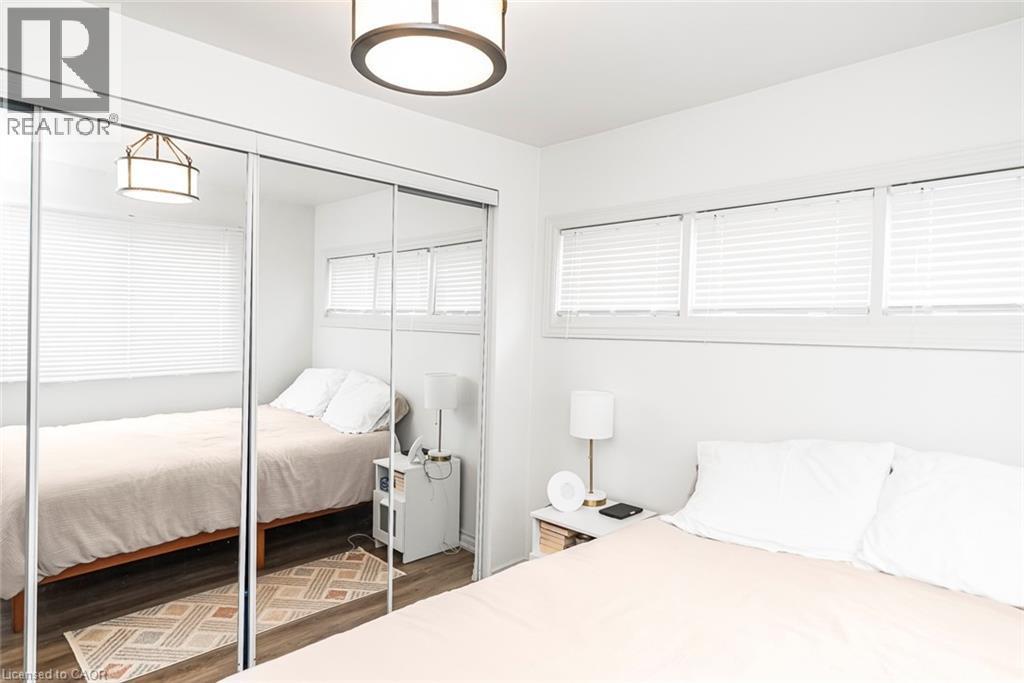 Bedroom featuring a closet and dark wood-style flooring - 57 New Street, Hamilton, ON - Indoor Photo Showing Bedroom