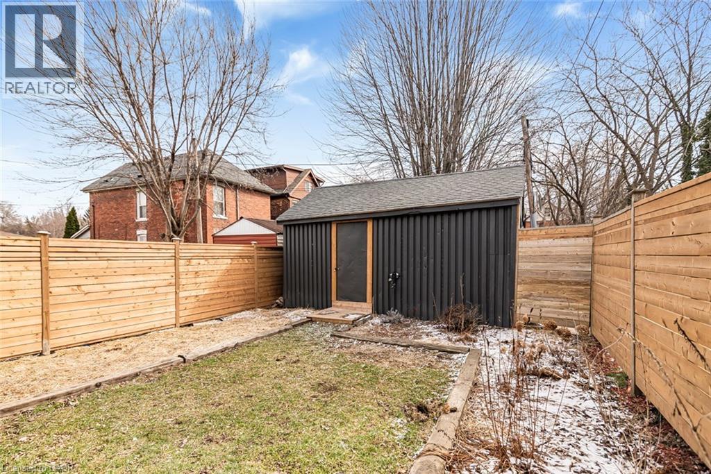 Fenced backyard with a shed - 57 New Street, Hamilton, ON - Outdoor