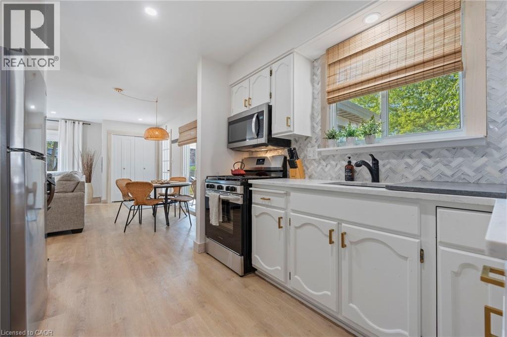 Kitchen with appliances with stainless steel finishes, white cabinetry, plenty of natural light, decorative backsplash, and recessed lighting - 181 Cedar Drive, Turkey Point, ON - Indoor Photo Showing Kitchen