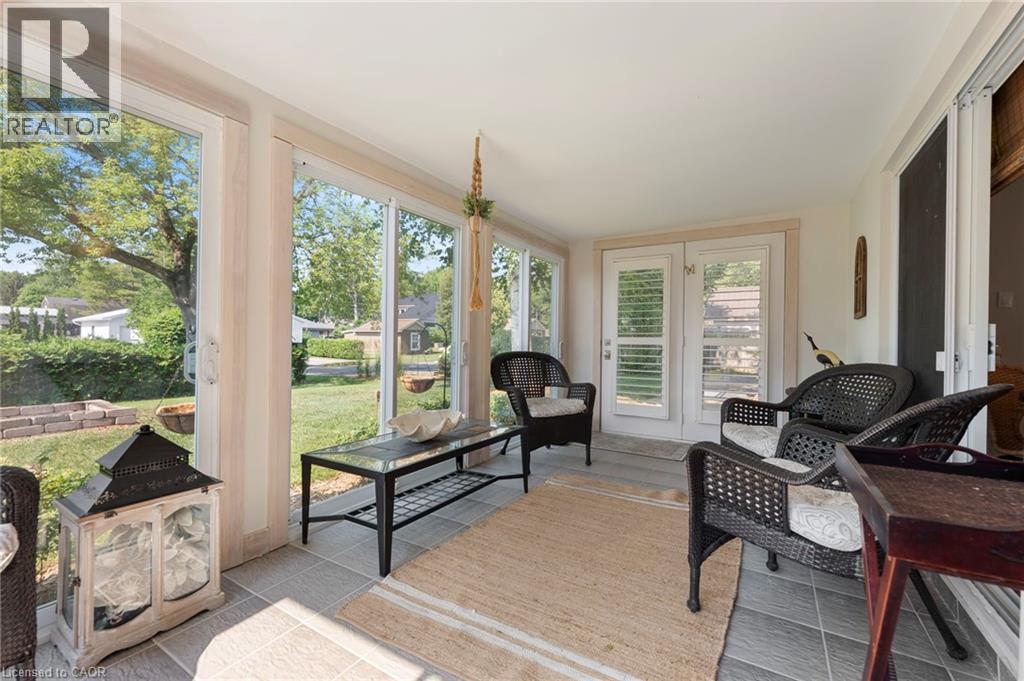 Sunroom featuring french doors, healthy amount of natural light, and tile patterned flooring - 181 Cedar Drive, Turkey Point, ON - Indoor