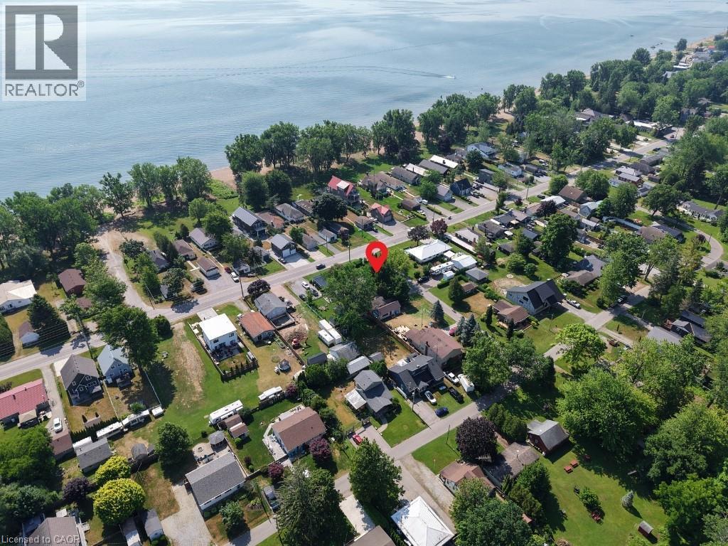 Aerial view of property and surrounding area featuring a nearby body of water and nearby suburban area - 181 Cedar Drive, Turkey Point, ON - Outdoor With Body Of Water With View