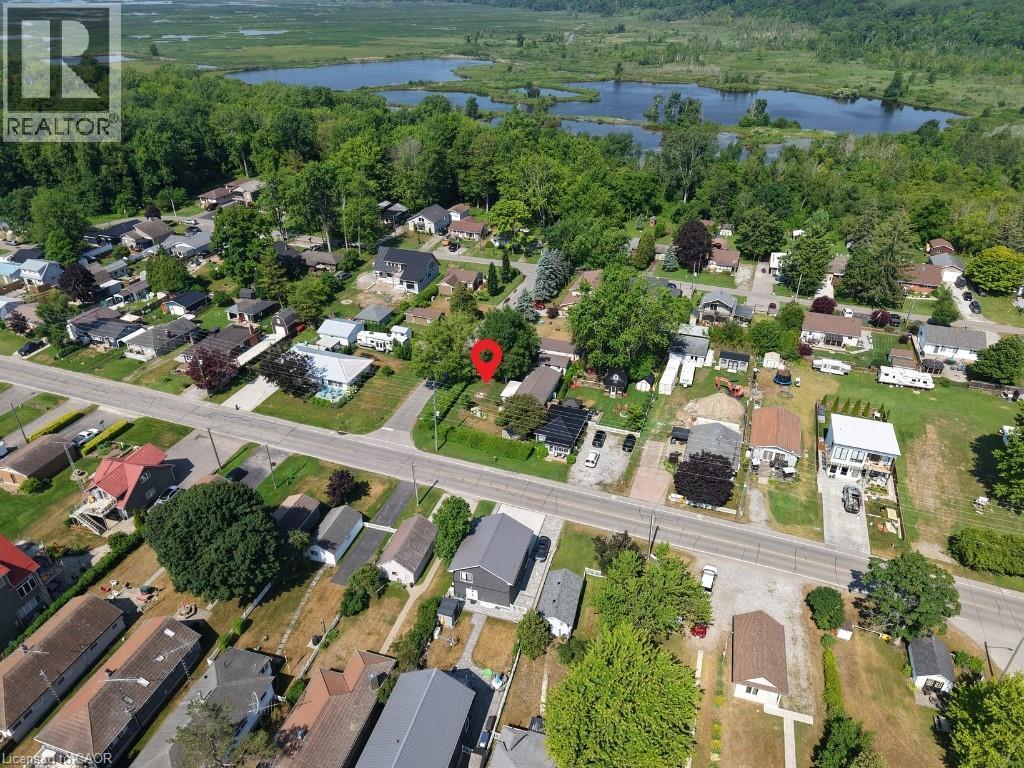 Aerial overview of property's location with a large body of water and nearby suburban area - 181 Cedar Drive, Turkey Point, ON - Outdoor With Body Of Water With View