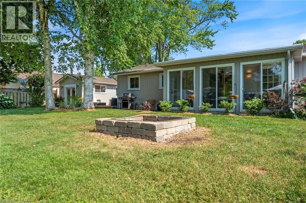 Rear view of house with an outdoor fire pit - 181 Cedar Drive, Turkey Point, ON - Outdoor