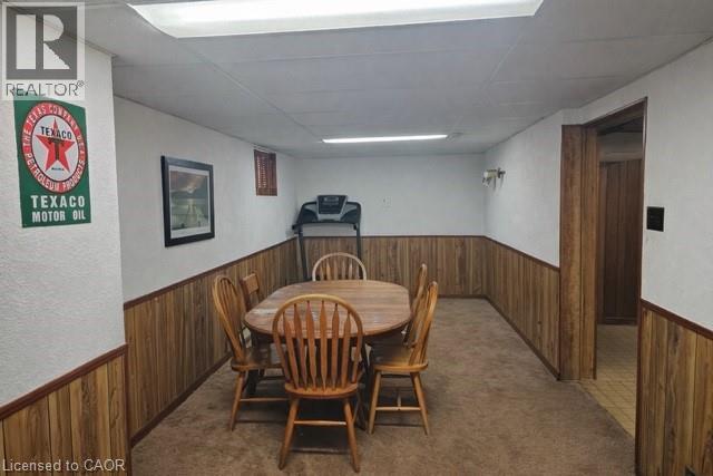 Dining space with wooden walls, wainscoting, a paneled ceiling, and dark carpet - 226 Auburn Avenue, Hamilton, ON - Indoor