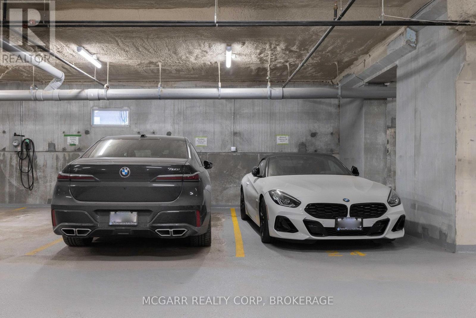 Street level double indoor parking - 401 - 77 Yates Street, St. Catharines (Downtown), ON - Indoor Photo Showing Garage