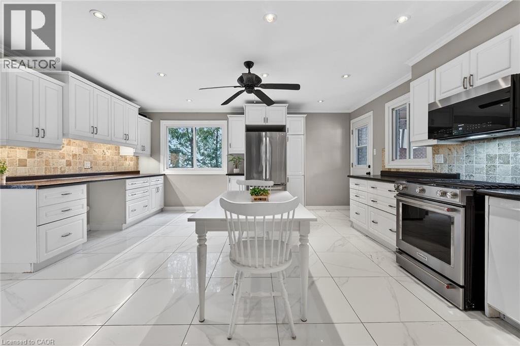 Kitchen featuring tasteful backsplash, stainless steel appliances, white cabinetry, recessed lighting, and ornamental molding - 22 Woodside Drive, Hamilton, ON - Indoor Photo Showing Kitchen With Upgraded Kitchen