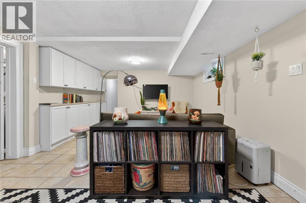 Kitchen with white cabinets, a textured ceiling, light tile patterned flooring, and light countertops - 22 Woodside Drive, Hamilton, ON - Indoor