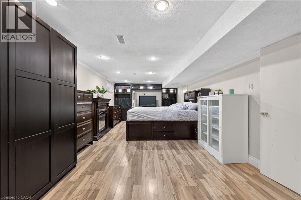Bedroom with a textured ceiling, light wood finished floors, recessed lighting, and ornamental molding - 22 Woodside Drive, Hamilton, ON - Indoor
