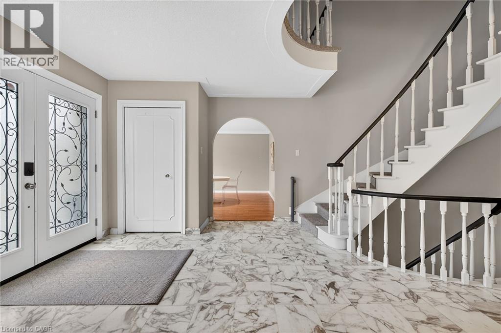 Foyer with french doors, arched walkways, and light marble finish floors - 22 Woodside Drive, Hamilton, ON - Indoor Photo Showing Other Room