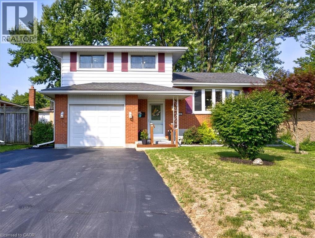 Attached 1 car garage with inside access door to home. - 12 Miller Crescent, Simcoe, ON - Outdoor With Facade