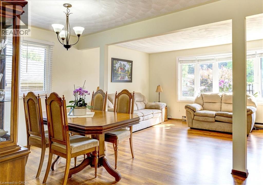 Dining and living rooms have laminate flooring. - 12 Miller Crescent, Simcoe, ON - Indoor Photo Showing Dining Room