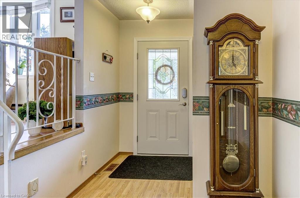 Foyer with large closet and inside access to the garage - 12 Miller Crescent, Simcoe, ON - Indoor Photo Showing Other Room