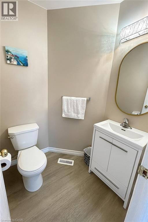 Half bathroom with vanity and light wood-style flooring - 988 Prosperity Court, London, ON - Indoor Photo Showing Bathroom