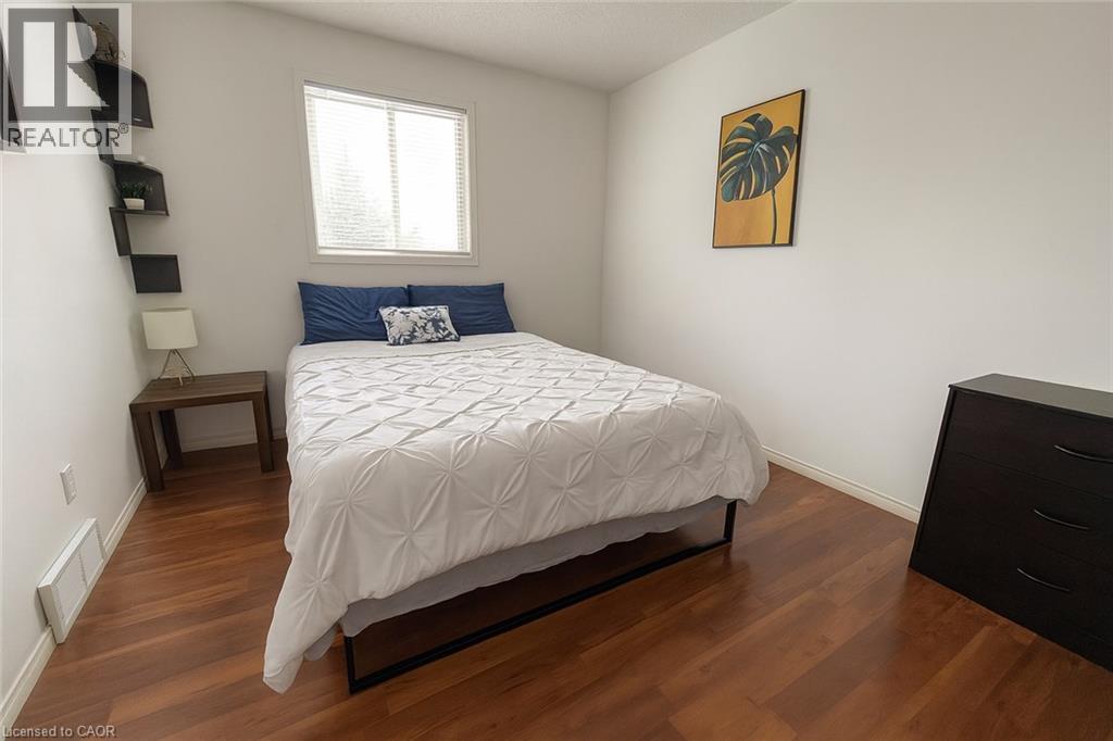 Bedroom featuring dark wood-type flooring and baseboards - 988 Prosperity Court, London, ON - Indoor Photo Showing Bedroom
