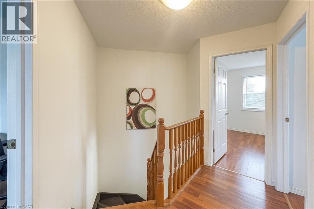 Corridor featuring an upstairs landing, wood finished floors, and a textured ceiling - 988 Prosperity Court, London, ON - Indoor Photo Showing Other Room
