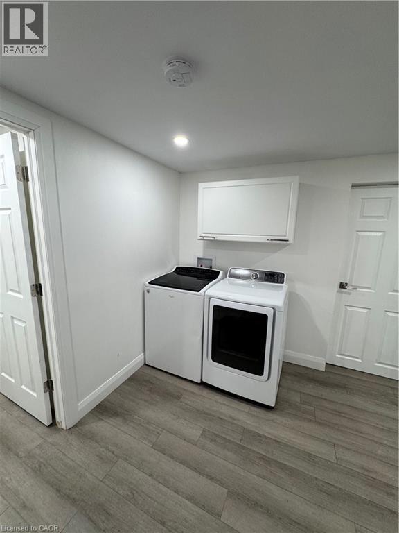 Laundry room featuring light wood finished floors, separate washer and dryer, and recessed lighting - 18 Cyprus Drive Unit# Lower, Kitchener, ON - Indoor Photo Showing Laundry Room