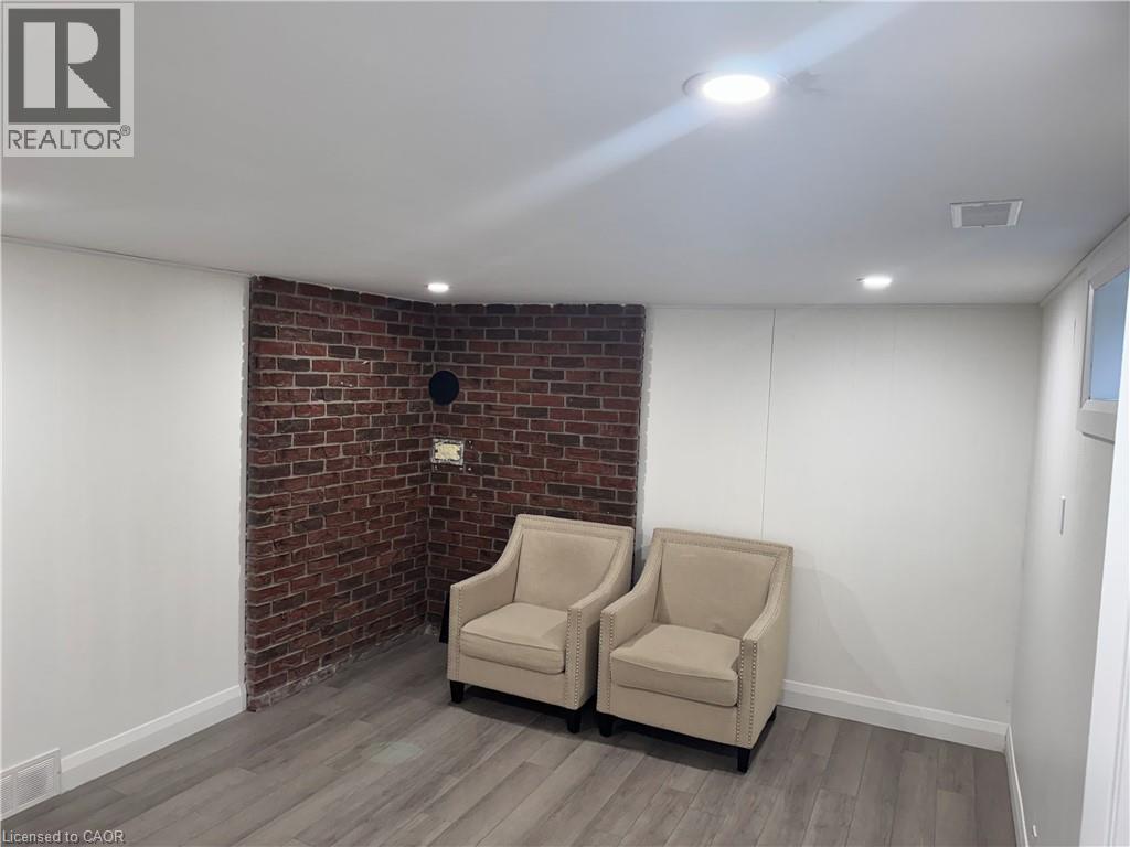 Sitting room featuring brick wall, wood finished floors, and recessed lighting - 18 Cyprus Drive Unit# Lower, Kitchener, ON - Indoor Photo Showing Other Room