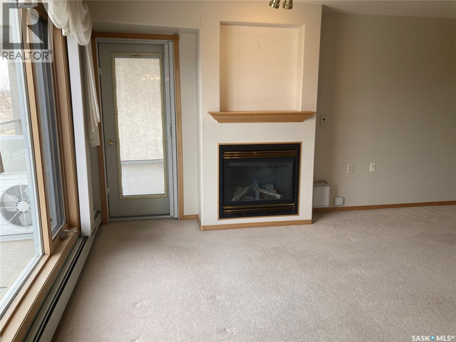 329 325 Keevil Crescent, Saskatoon, SK - Indoor Photo Showing Living Room With Fireplace