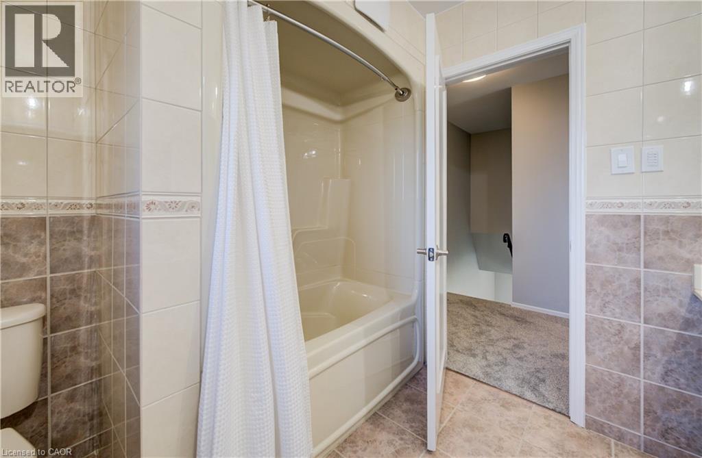 Durable and hygienic acrylic tub/shower combo. - 63 Kingston Crescent, Kitchener, ON - Indoor Photo Showing Bathroom