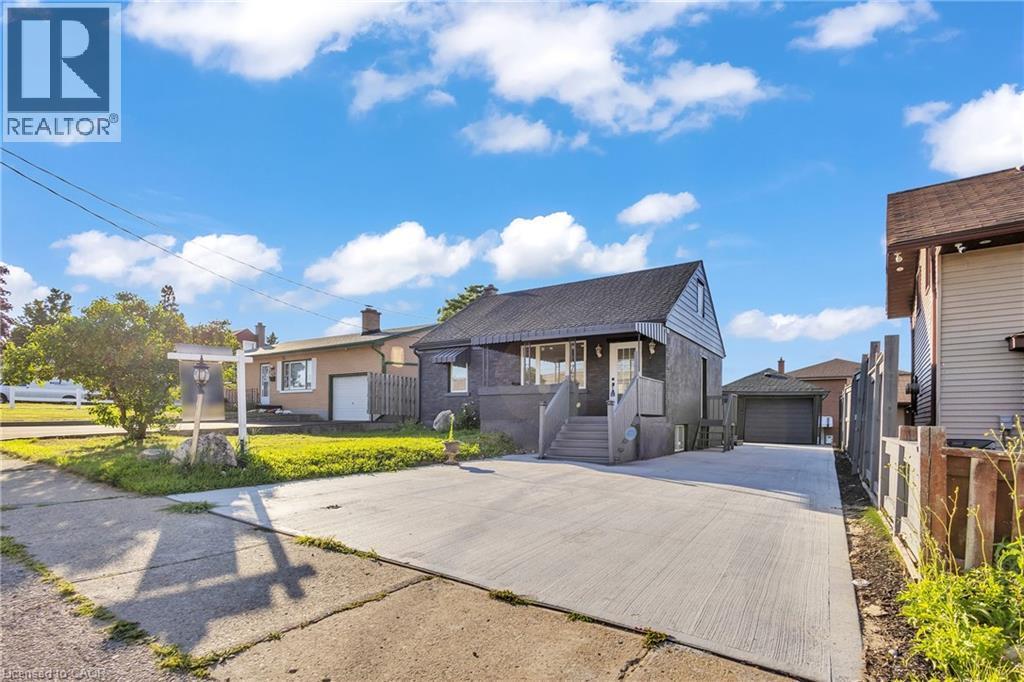 View of front of house with an outdoor structure and a garage - 84 Avalon Place, Kitchener, ON - Outdoor With Facade