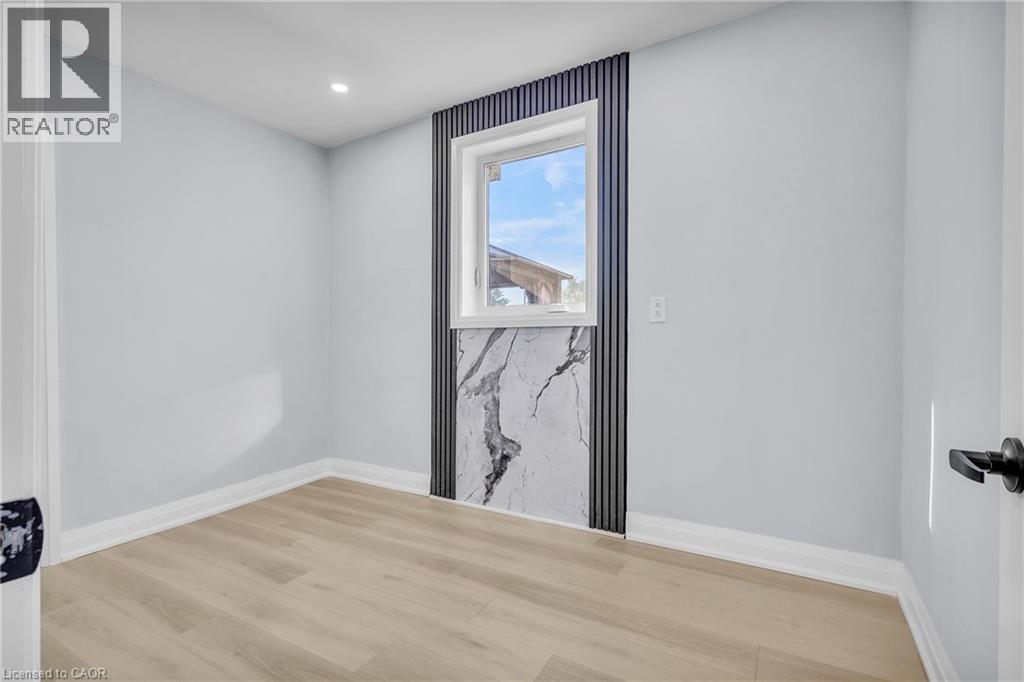 Empty room with light wood-type flooring and recessed lighting - 84 Avalon Place, Kitchener, ON - Indoor Photo Showing Other Room