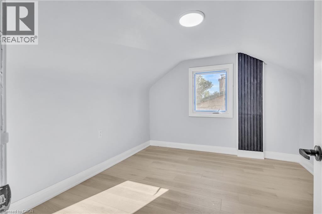 Bonus room with light wood-type flooring and vaulted ceiling - 84 Avalon Place, Kitchener, ON - Indoor Photo Showing Other Room