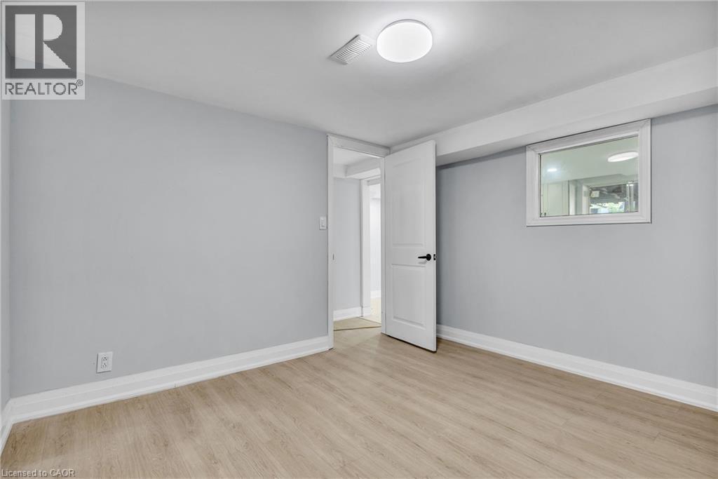 Unfurnished bedroom with baseboards and light wood-style flooring - 84 Avalon Place, Kitchener, ON - Indoor Photo Showing Other Room