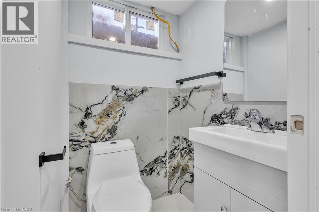 Half bathroom featuring vanity and toilet - 84 Avalon Place, Kitchener, ON - Indoor