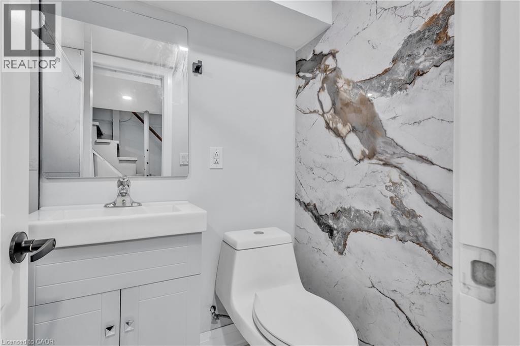 Half bathroom featuring vanity and toilet - 84 Avalon Place, Kitchener, ON - Indoor Photo Showing Bathroom