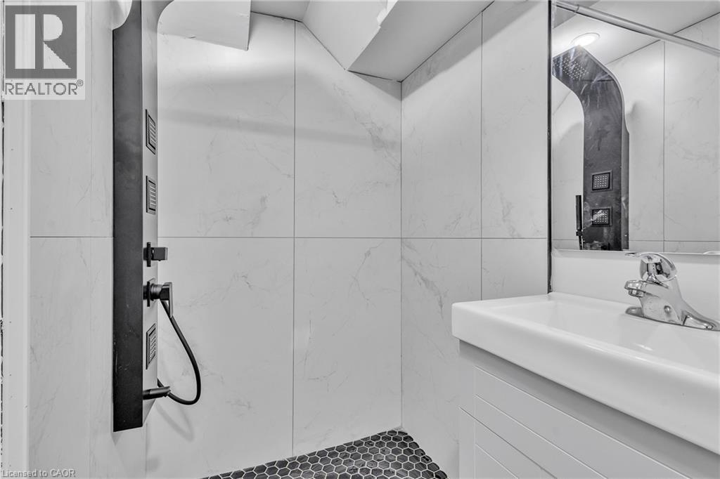 Full bathroom featuring vanity, a marble finish shower, and tile walls - 84 Avalon Place, Kitchener, ON - Indoor Photo Showing Bathroom