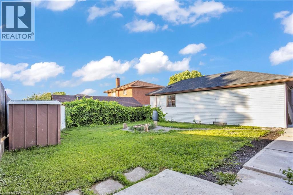 View of green lawn featuring a storage unit - 84 Avalon Place, Kitchener, ON - Outdoor