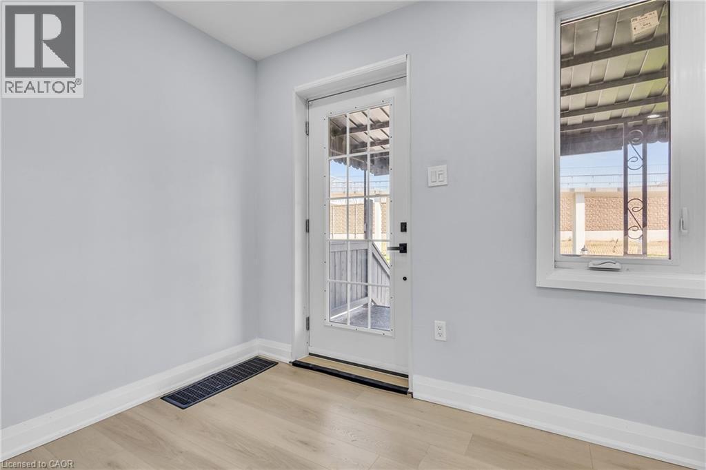 Doorway to outside featuring baseboards and wood finished floors - 84 Avalon Place, Kitchener, ON - Indoor Photo Showing Other Room