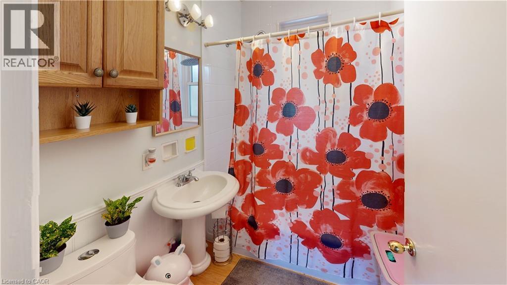 Bathroom featuring a shower with curtain and light wood-type flooring - 10 Armstrong Avenue, Hamilton, ON - Indoor Photo Showing Bathroom