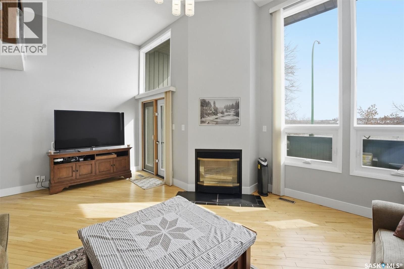 14 455 Pinehouse Drive, Saskatoon, SK - Indoor Photo Showing Living Room With Fireplace