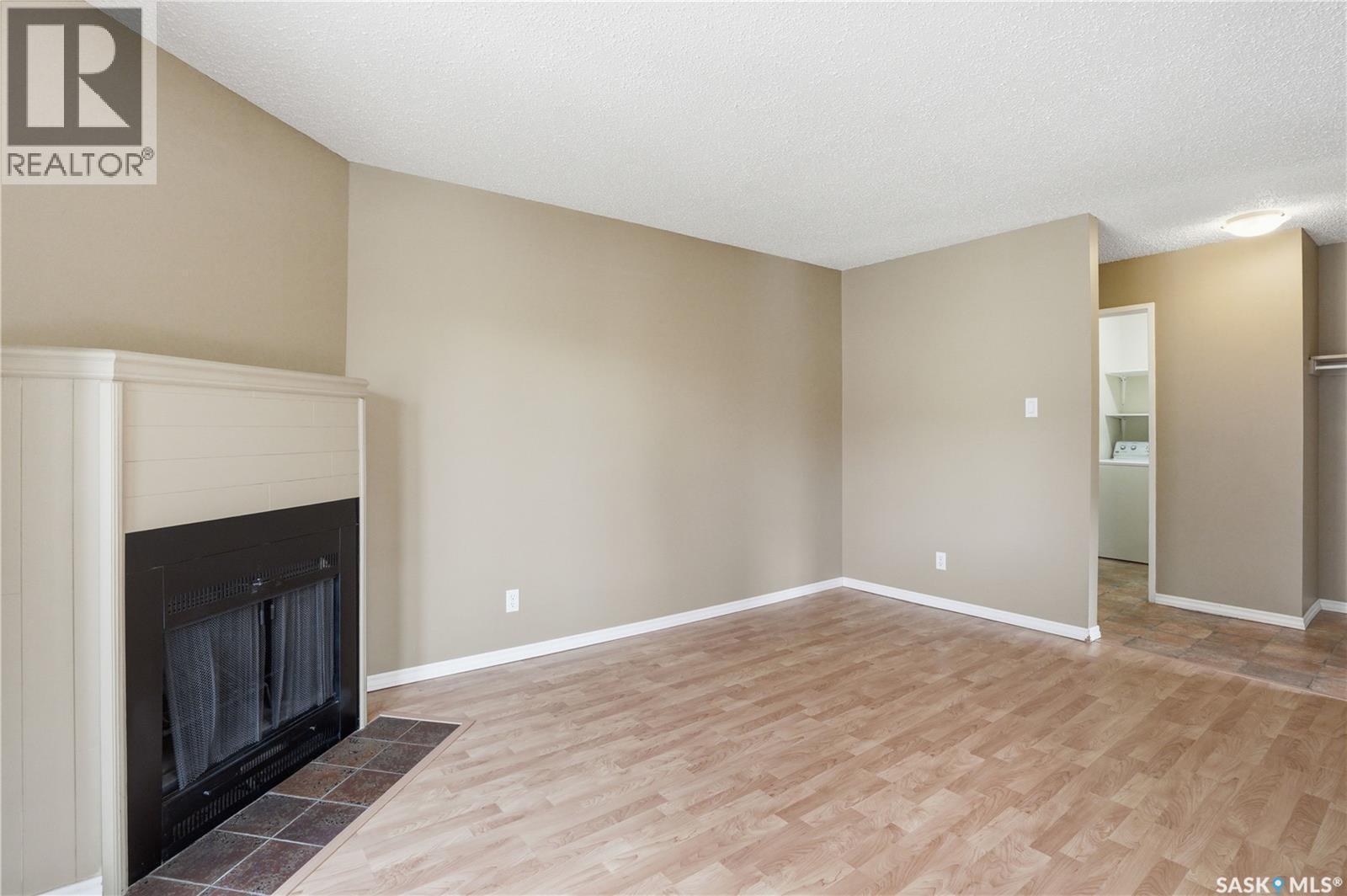 208B 4040 8Th Street E, Saskatoon, SK - Indoor Photo Showing Other Room With Fireplace