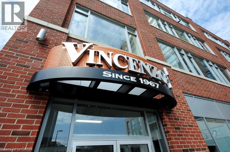 View of building exterior featuring a garage - 191 King Street S Unit# 712, Waterloo, ON - Outdoor With Exterior