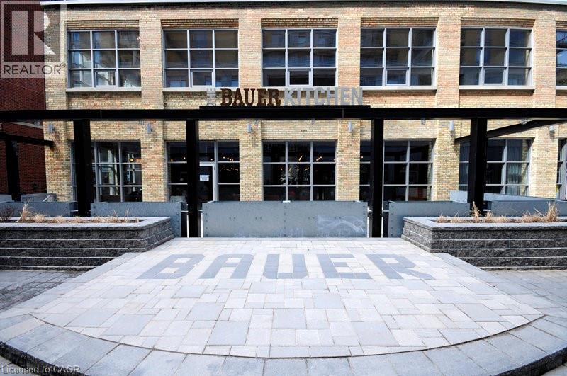 Property entrance featuring brick siding and a patio area - 191 King Street S Unit# 712, Waterloo, ON - Outdoor With Facade