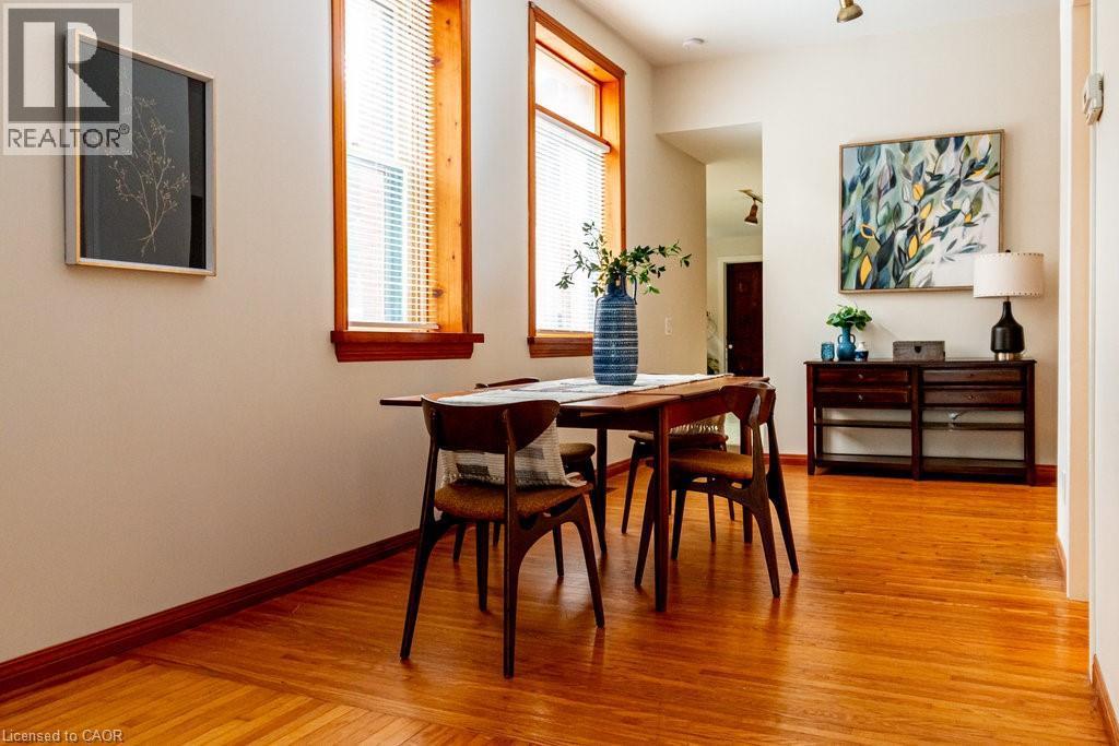 Dining area with light wood finished floors - 218 Bay Street S, Hamilton, ON