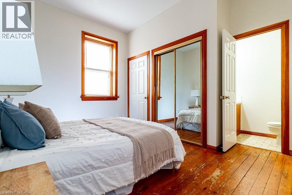 Bedroom with hardwood / wood-style flooring and a closet - 218 Bay Street S, Hamilton, ON