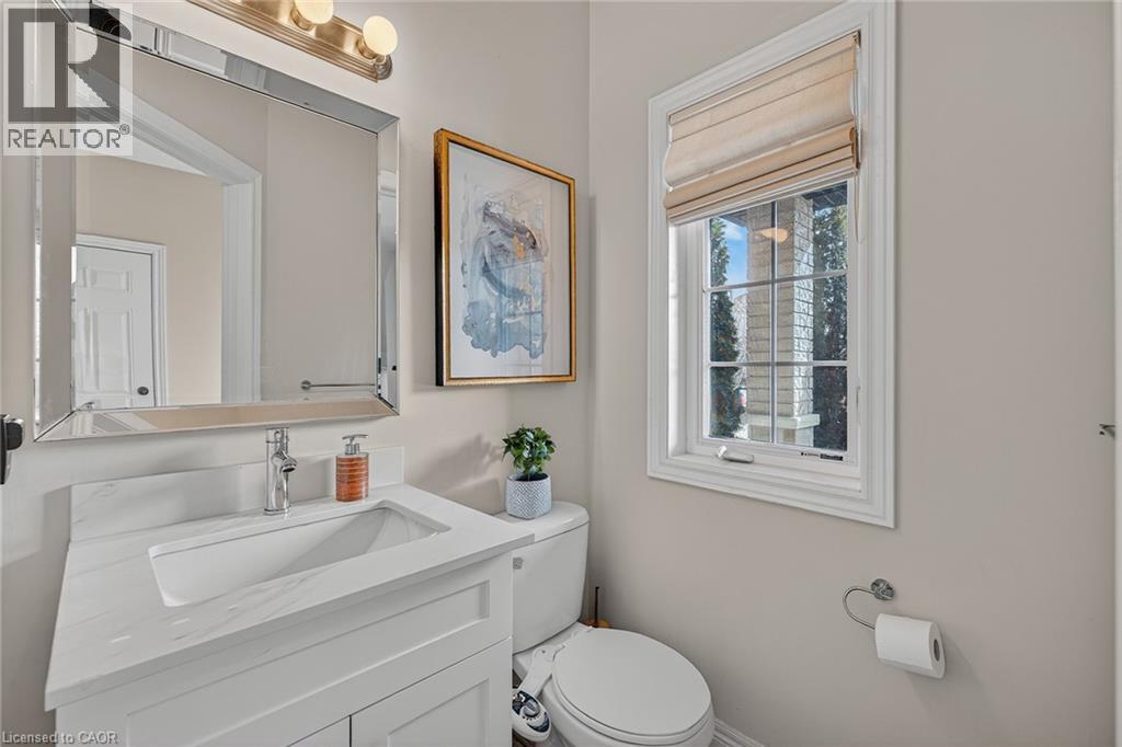 Half bathroom featuring toilet and vanity - 100 Garinger Crescent, Binbrook, ON - Indoor Photo Showing Bathroom