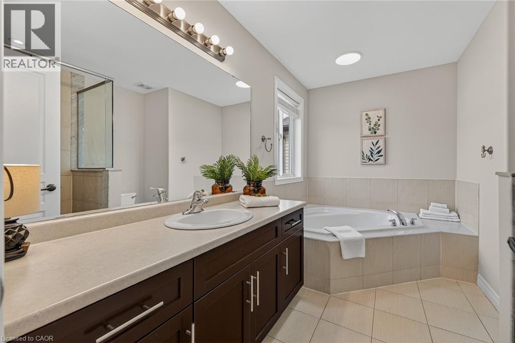 Full bathroom with a bath, vanity, a tile shower, and light tile patterned floors - 100 Garinger Crescent, Binbrook, ON - Indoor Photo Showing Bathroom