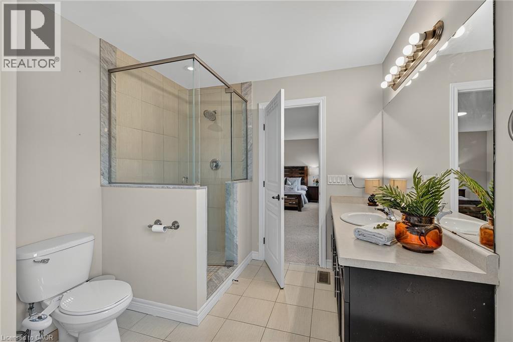 Ensuite bathroom featuring vanity, a shower stall, and light tile patterned flooring - 100 Garinger Crescent, Binbrook, ON - Indoor Photo Showing Bathroom